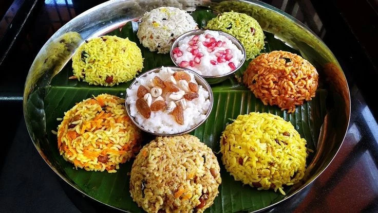 Valaikappu variety rice platter with curd rice and sweet rice on a banana leaf